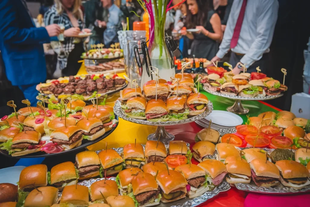 Party table with a variety of beef, chicken, and vegetarian sliders